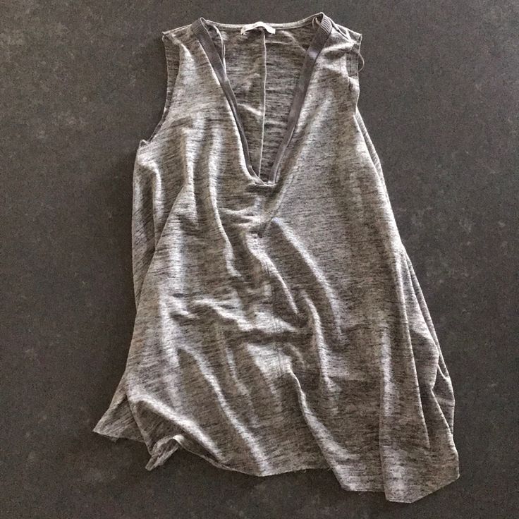 Never Worn Zara Tank. Great Dressing Up For Work And Dressing Down During The Weekends. Has A Silver Shimmer To It, Raw Hems And Awesome Plunge Neckline Chic Silver V-neck Top, Chic Silver Sleeveless Top, Casual Silver Sleeveless Tank Top, Casual Silver Sleeveless Top, Zara V-neck Tank Top For Night Out, Chic Silver Tank Top For Summer, Zara V-neck Tops For Layering, Zara Gray Summer Top, Plunge Neckline