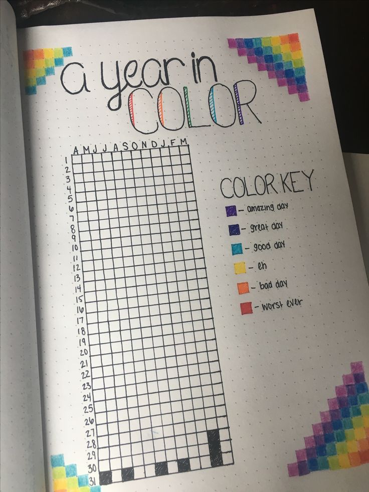 an open notebook with a crossword puzzle on the page and a year in color chart