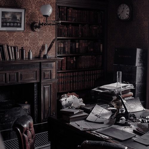 an old fashioned desk with many books and papers on it in front of a fireplace