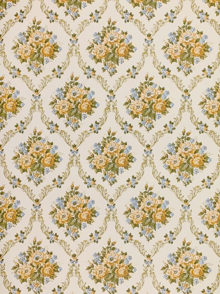 an old fashioned wallpaper with flowers and leaves on it's side, in yellow and blue colors