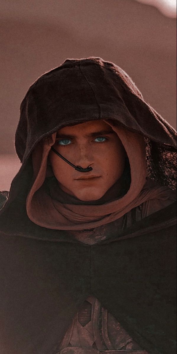 a man in a hooded jacket with blue eyes