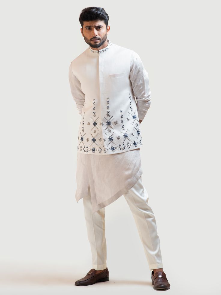 This Cream Phulkari Nehru Kurta Set will instantly give an elegant look. This 3 piece kurta set features a linen satin cream kurta with overlapping silhouette, high and low panels, stitch line borders, and motif embroidery. A Nehru jacket enhanced with Phulkari stitch details, pipe work embroidery, invisible front button placket, and a mandarin collar. It is paired with narrow fitted pajama pants in cream color and malai cotton fabric. An ideal outfit for traditional occasions, and special event Nehru Jacket For Men, Boys Kurta Design, Phulkari Embroidery, Mens Kurta Designs, Nehru Jacket, Mens Casual Dress Outfits, Embroidered Collars, Nehru Jackets, How To Look Handsome