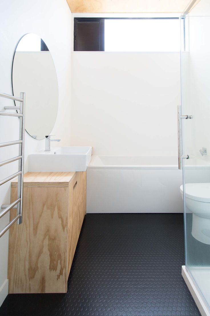 a bathroom with a sink, toilet and bathtub next to a shower stall in the corner