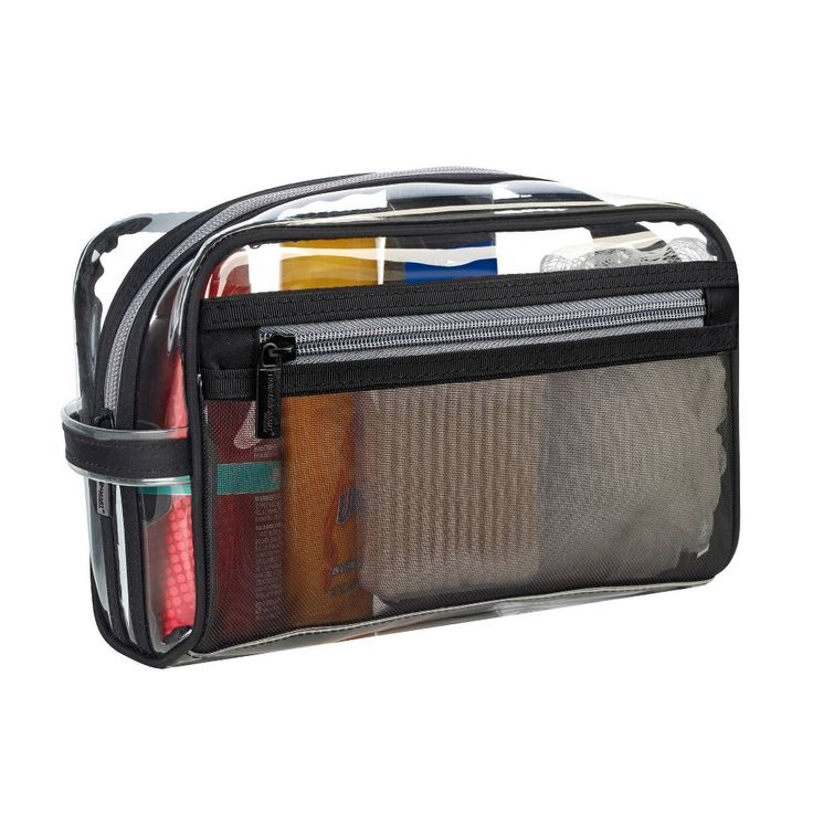 an open toiletry bag filled with lots of items on top of a white surface