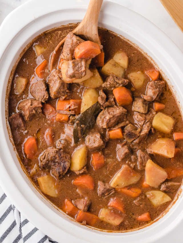 a white bowl filled with stew and carrots