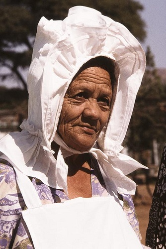 an old woman wearing a white head covering