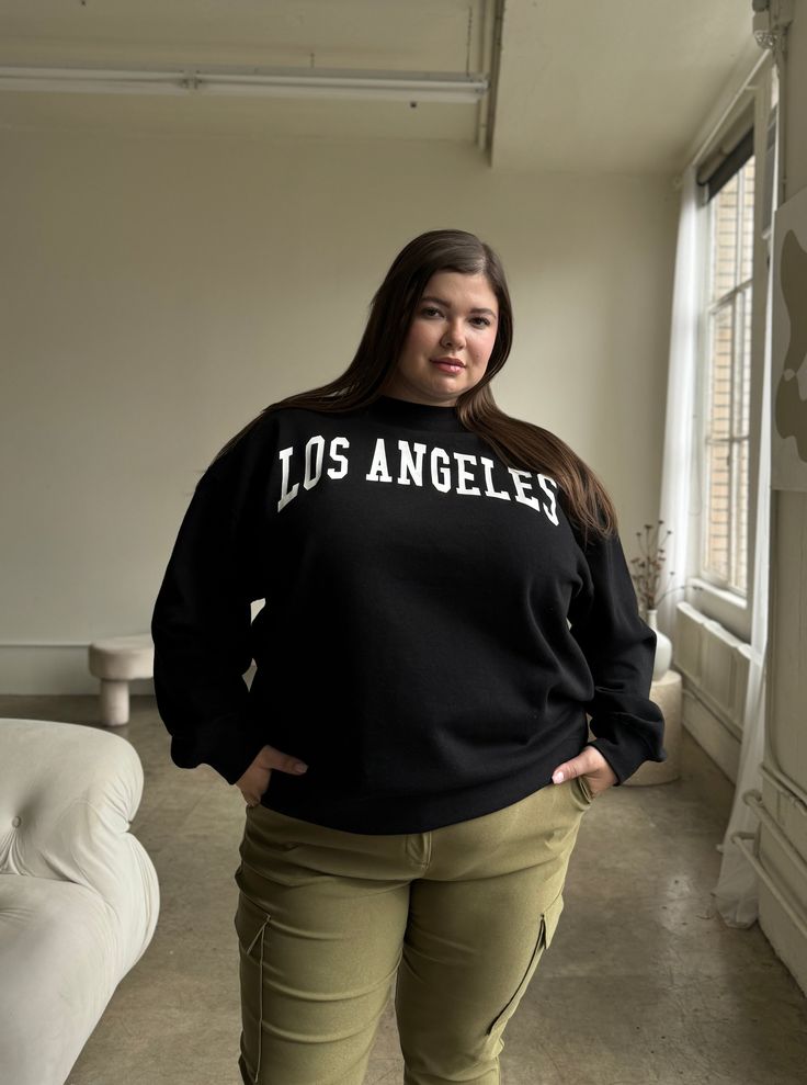 Introducing the Plus Size Los Angeles Crewneck Sweatshirt - a stylish addition to any wardrobe. This sweatshirt offers fashion-forward trends, allowing you to look fun and trendy in a preppy way. Plus, this is one of the softest sweatshirts we have ever stocked. This sweatshirt features a crewneck neckline, long sleeves, a comfortable oversized fit, and words across the chest. The material is an incredibly soft, cozy woven. This pullover sweatshirt is made out of 60% Cotton and 40% Polyester. Im Trendy Long Sleeve Comfortable Sweatshirt, Trendy Comfortable Fit Tops For Winter, Trendy Winter Tops With Comfortable Fit, Trendy Comfortable Winter Tops, Relaxed Fit Tops With Letter Print In French Terry, Trendy Fall Sweatshirt, Winter Long Sleeve Sweats For Campus, Trendy Crew Neck Sweats With Letter Print, Relaxed Fit French Terry Tops With Letter Print