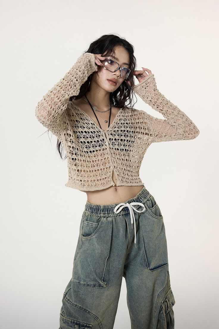 Experience the unique blend of comfort and style with our Crochet Crop Top, enriched with flare sleeves that exude a carefree spirit. Finely crafted with 100% polyester for durability, this cozy crop heading Top features a distinctive crochet pattern, adding a touch of texture and a flair to your wardrobe. Its loose knit design paired with flare sleeves offers both breathability and an edgy fashion statement, perfect for trendsetters. Pair it with high-waisted jeans or relaxed cargo pants for a laid-back look, or dress it up with a chic maxi skirt for an evening out. Ideal for a range of occasions, it embodies a fusion of freedom, passion, and creativity, making it more than just a piece of clothing - it's an attitude towards life. Product specifications: Material: 100 % PolyesterFit: Conv Casual Cropped Sweater For Summer, Trendy Cropped Summer Cardigan, Cropped Sweater For Summer, Trendy Long Sleeve Open Knit Crop Top, Trendy Cropped Sweater For Summer, Trendy Long Sleeve Cropped Sweater For Summer, Beige Cropped Stretch Sweater For Spring, Beige Stretch Cropped Sweater For Spring, Casual Stretch Cropped Sweater For Summer