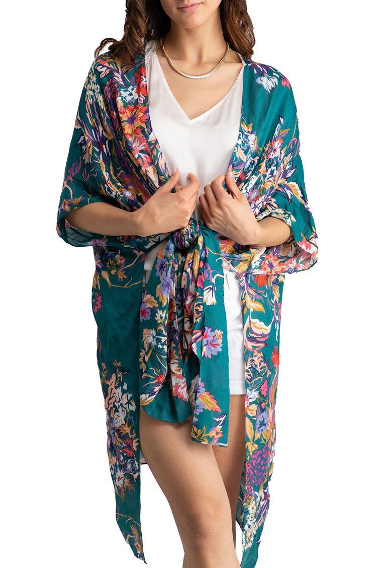 Love to layer in this eclectic long ruana styled in an ultra-comfortable, drapey silhouette and colorful floral pattern that is signature to Saachi's artisanal inspired brand. 34" x 44" Open front Short sleeves 100% rayon Hand wash cold, line dry Imported Model stats: 5'10", 32" bust, 25" waist, 36" hip. Model is wearing size OS. Bohemian Multicolor Robe For Spring, Multicolor Bohemian Spring Robe, Multicolor Bohemian Robe For Spring, Casual Beach Shawl For Spring, Green Bohemian Floral Robe, Bohemian Wrap Robe With Floral Print, Casual Multicolor Shawl For Spring, Spring Vacation Bohemian Shawl, One Size Green Bohemian Kimono