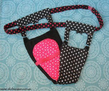 two pieces of black and pink fabric with polka dots on them, one is holding a cell phone in the other