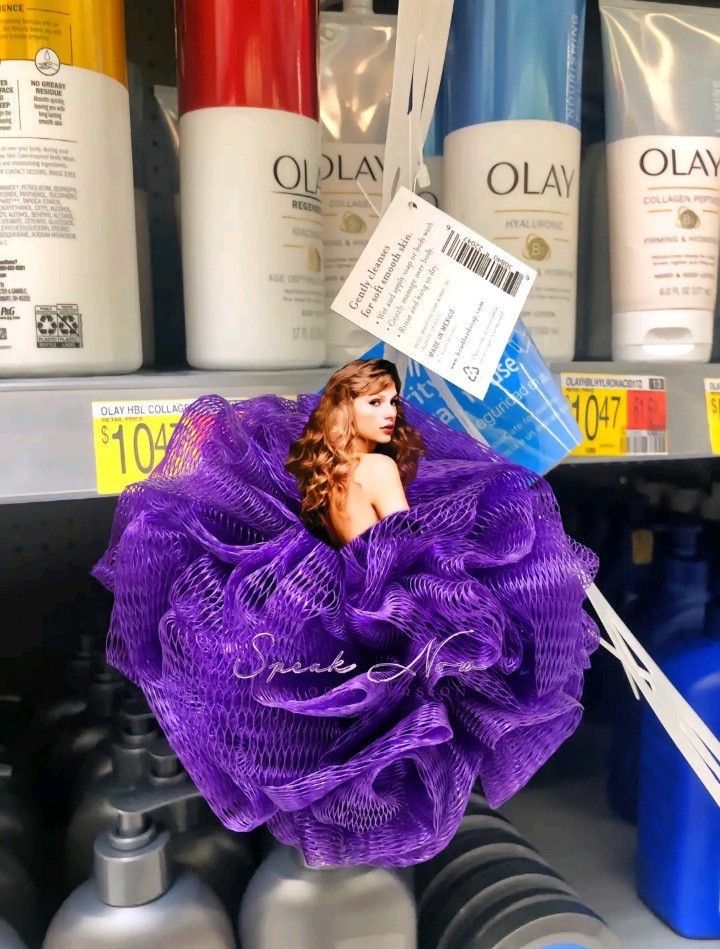 there is a purple flower in the middle of some hair care products on display for sale