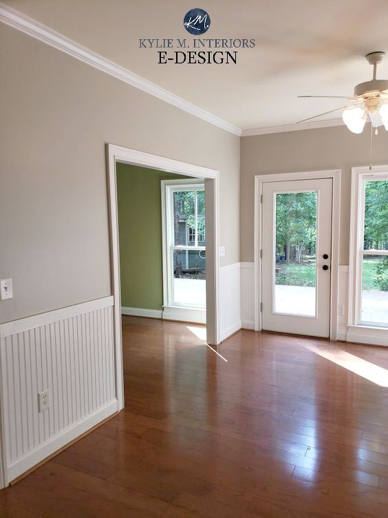 an empty living room with hard wood flooring and sliding glass doors leading to the patio