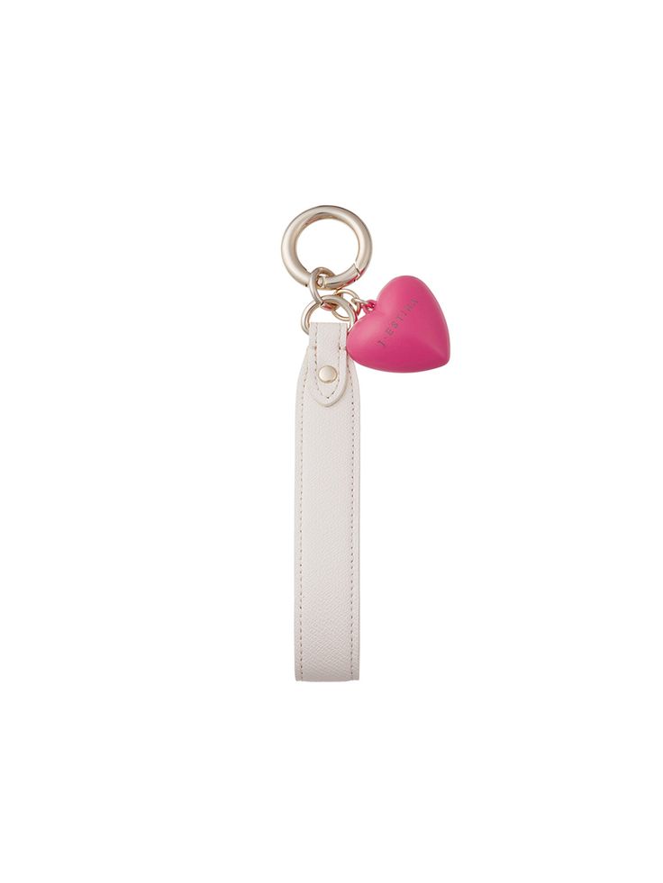 a white key chain with a pink heart on it