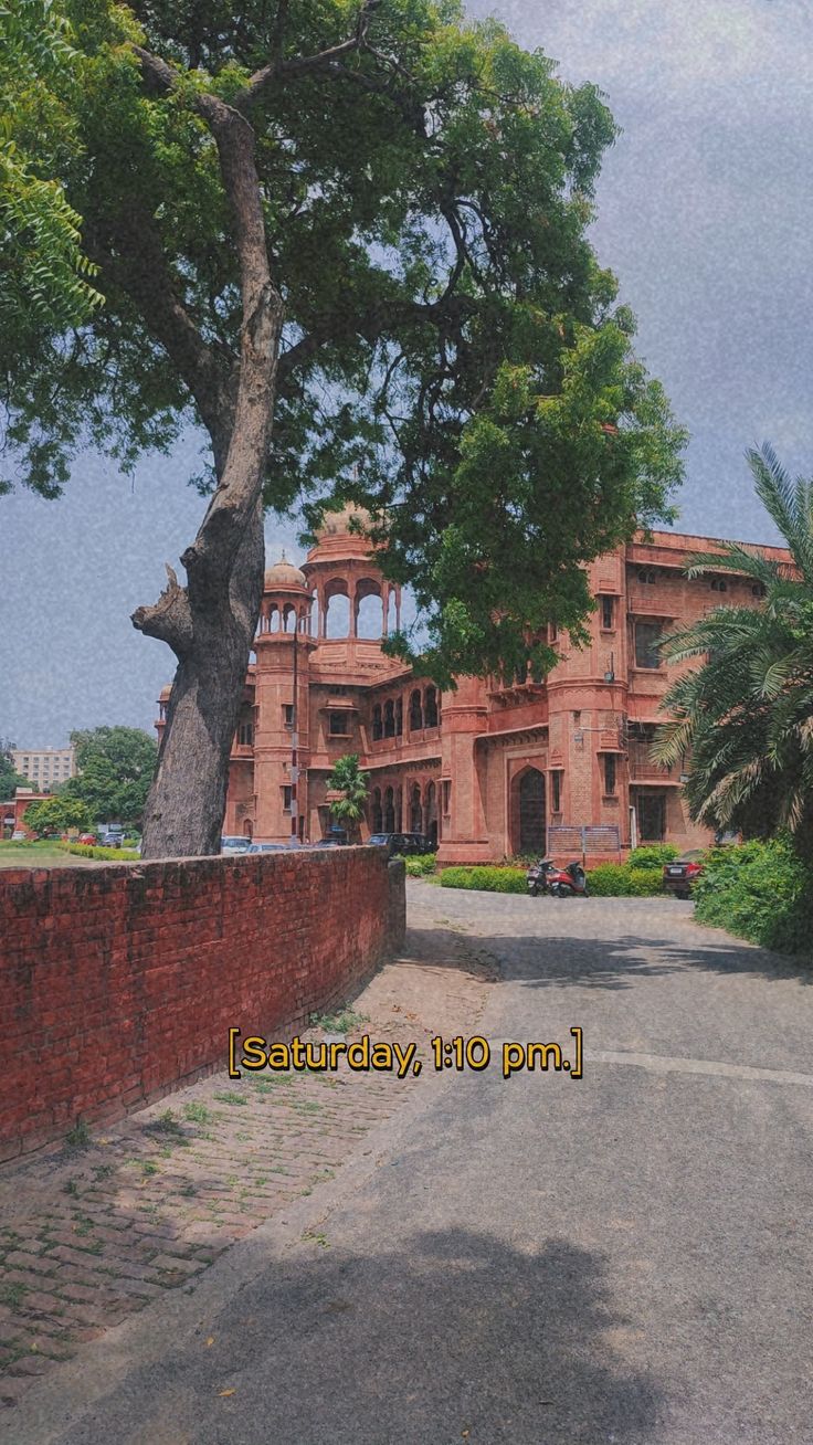 an old building with a tree in front of it