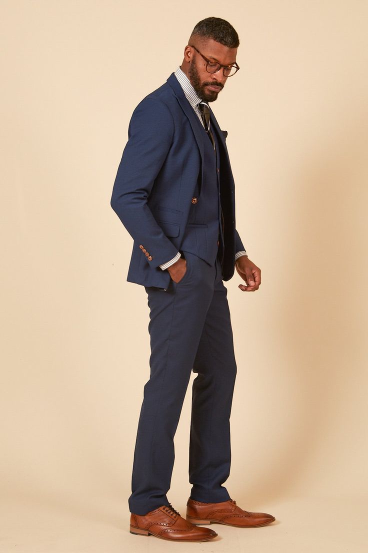 Official Leicester City F.C. Club Suit! From the daily grind to the office boardroom, make a sartorial statement with this Max three-piece suit, the official club suit of Leicester City first team. The sleek silhouette exudes confidence and is complemented by the subtle tan hue, allowing it to stand out in the ocean of mundane office attire. To add an extra touch of sophistication, an alluring circle print pocket square adds a modern finishing touch that turn heads. This suit is the perfect piec Blue Three Piece Suit, Navy Suit Wedding, Graduation Suits, Royal Blue Blazers, Tweed Wedding Suits, Cream Suit, Royal Blue Suit, Black Suit Wedding, Tan Suit