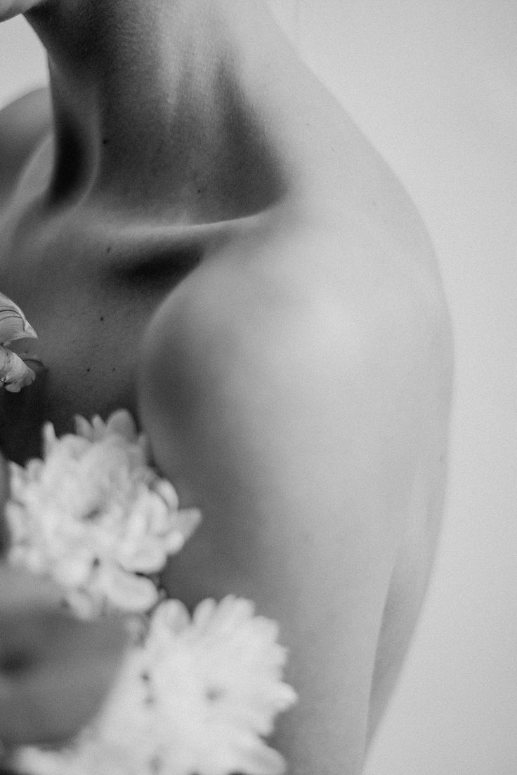 black and white photograph of a woman holding flowers