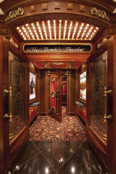 an ornately decorated entrance to a building with lights on the ceiling and marble floors