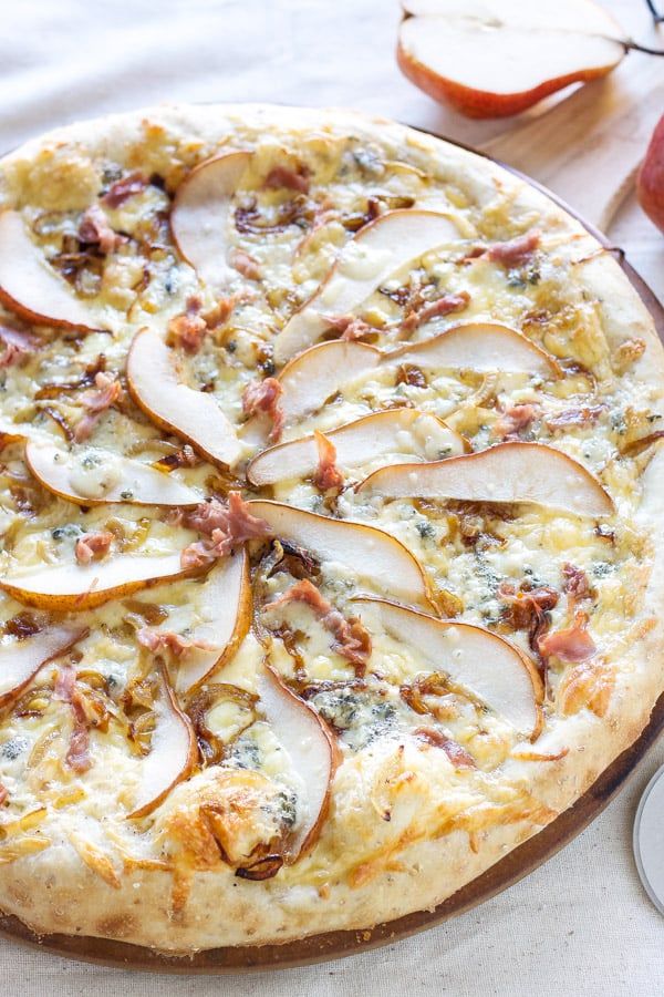 an apple and cheese pizza on a table