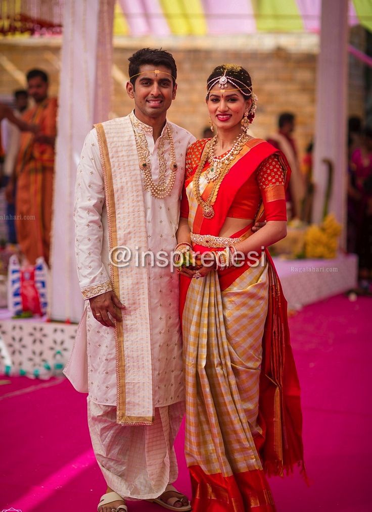 a man and woman standing next to each other in front of a pink carpeted area