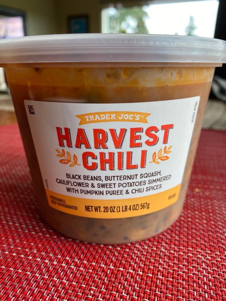 a container of trader joe's harvest chili sits on a table