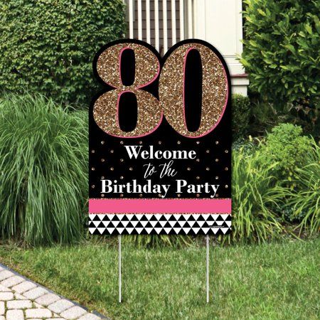 a sign that says welcome to the 80th birthday party in front of some bushes