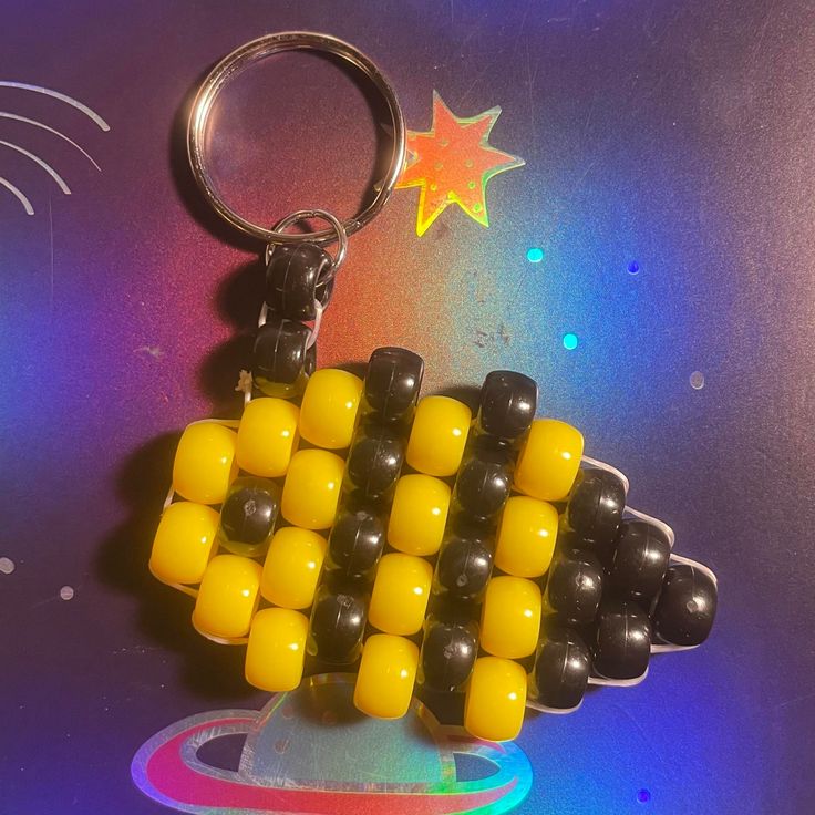 a keychain made out of legos on a table with a star in the background