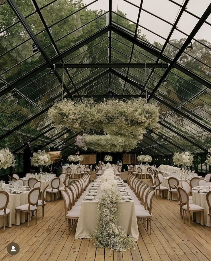 an indoor dining area with tables and chairs set up for a formal dinner or party