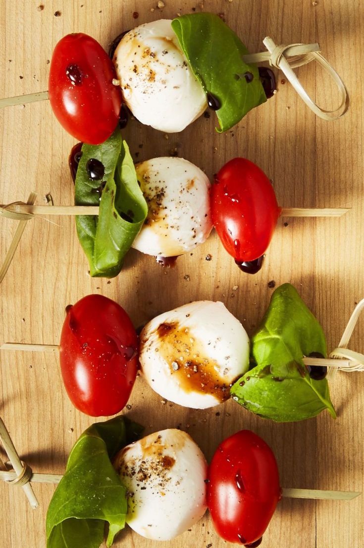 tomatoes, mozzarella and spinach on skewers ready to be grilled