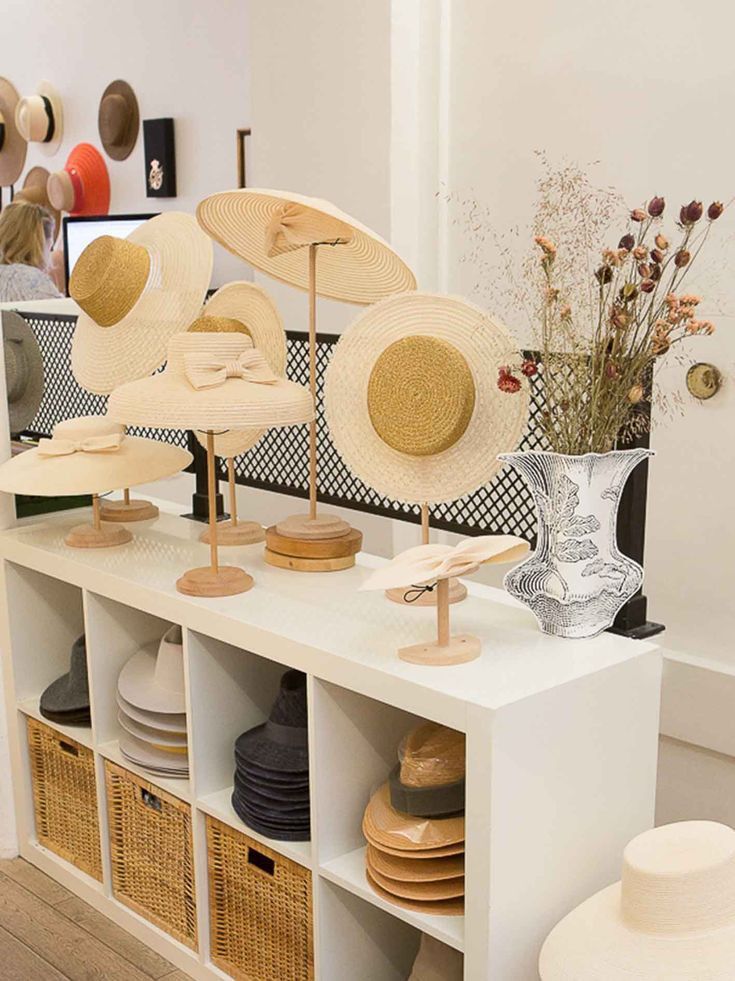 hats on display in a store with baskets and vases