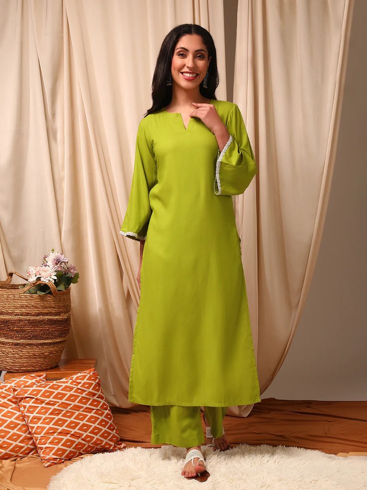 This green Kurta with Trousers set is made from a luxurious silk blend fabric, creating a stylish and comfortable outfit. The Kurta features a straight shape and round neck with flared three-quarter sleeves, while the Trousers have a partially elasticated waistband and slip-on closure for ease of wear. With a calf leng Festive Green Straight Pants, Green Straight Kurta Pant Set For Spring, Spring Green Workwear Pant Set, Green Pant Set For Spring Workwear, Spring Workwear Green Pant Set, Spring Long Sleeve Rayon Sets, Elegant Summer Sets With 3/4 Sleeve, Elegant Green Summer Pant Set, Green Straight Pant Set For Summer