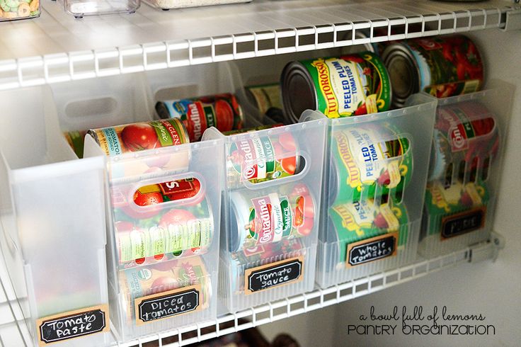 an organized refrigerator with canned food in bins