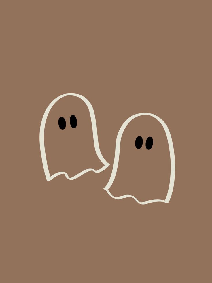 two white ghost heads with black eyes on a brown background