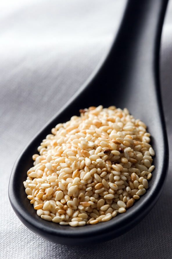 sesame seeds in a spoon on a table