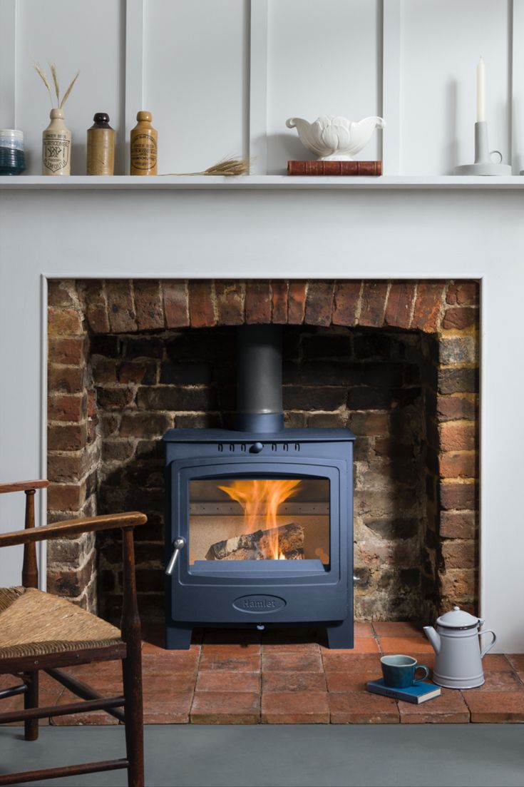 a fireplace with a wood burning stove in it