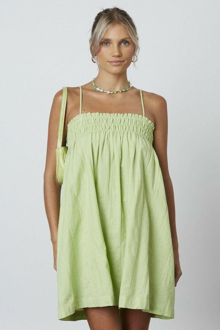 STYLE INFORMATION: Throw on the Lucy Apple Green Shift Dress and head to your next getaway in style! Woven tone on tone striped fabric falls from spaghetti straps into a straight neckline with smocked detail and shift bodice DETAILS & CARE: Cotton. Machine wash cold. Imported. SHIPPING: Orders are processed within 1-2 business days. Packages are shipped out Monday-Friday, holidays are excluded. Casual Sundress With Straight Neckline For Brunch, Green Mini Dress With Straight Neckline For Spring, Spring Green Mini Dress With Straight Neckline, Green Mini Dress With Straight Neckline, Spring Mini Dress With Square Neck And Gathered Neckline, Spring Mini Dress With Gathered Neckline And Square Neck, Casual Dresses With Straight Neckline For Daywear, Chic Sundress With Straight Neckline For Vacation, Spring Vacation Mini Dress With Gathered Neckline