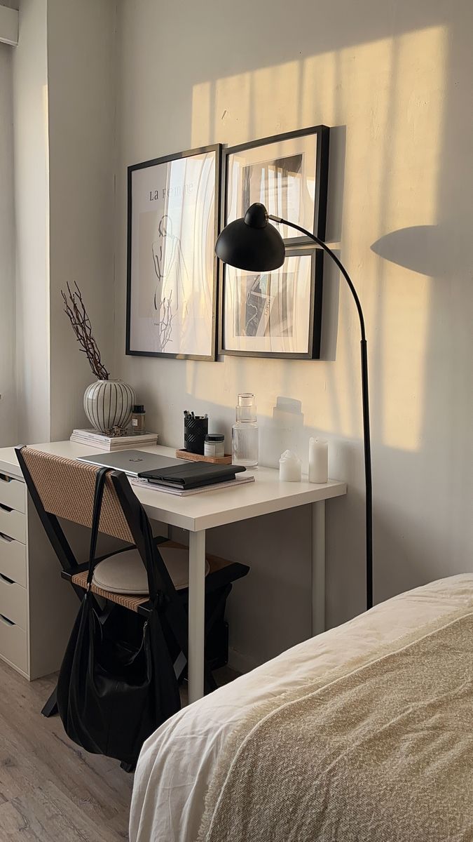 a bedroom with a desk, chair and lamp in it's corner area next to a bed