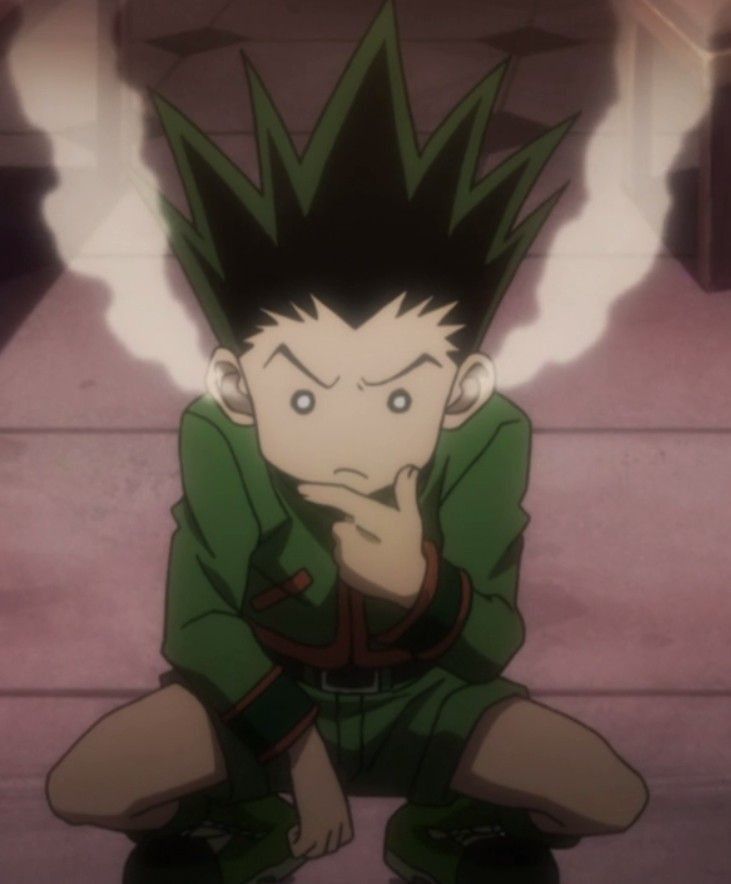 an anime character sitting on the ground with his hand to his face