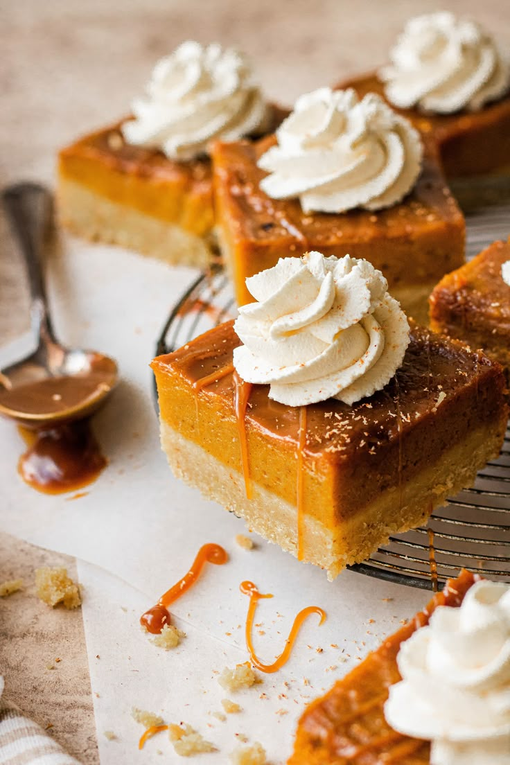 slices of pumpkin pie with whipped cream and caramel drizzled on top