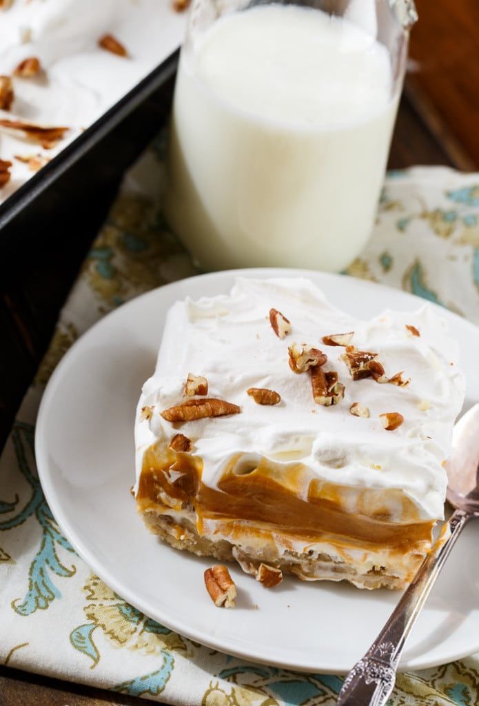 a white plate topped with dessert next to a glass of milk