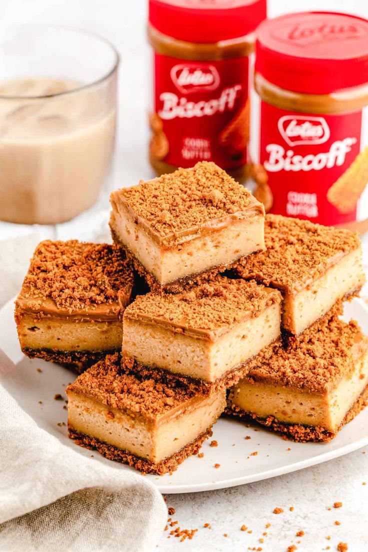 several pieces of cake on a plate next to jars of peanut butter and cinnamon sugar