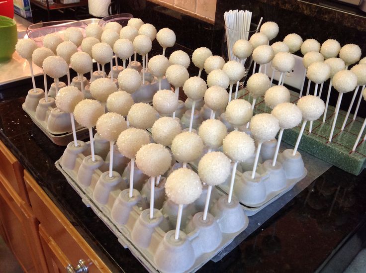 there are many white cake pops on the table