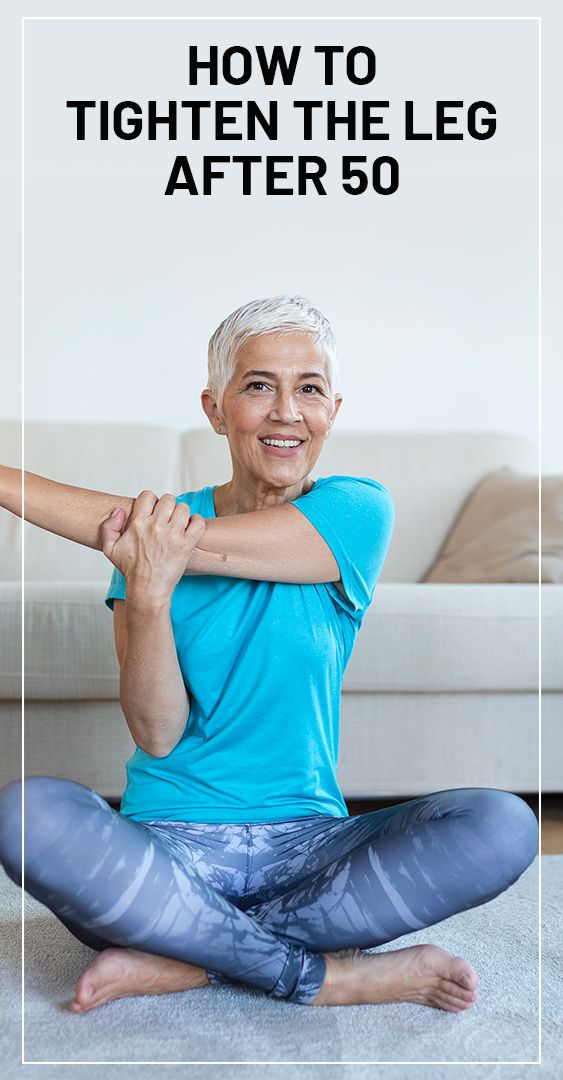 an older woman sitting on the floor doing yoga