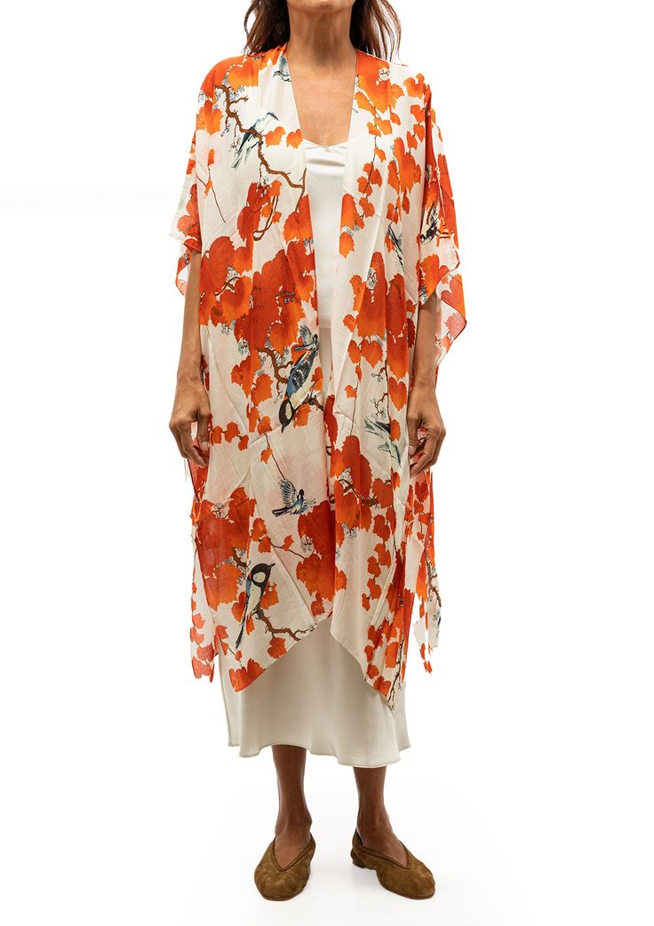 This popular kimono is made of a custom blend of modal and viscose which creates a silky smooth lightweight material while having a more sustainable impact on the environment. This long kimono jacket complete with wide 3/4 length sleeves can be worn for any occasion, whether you pair it with a neutral cami or layer it over a little black dress, it can make the perfect addition to your outfit. Kimonos come in one generous size but have been made to look flattering on all body shapes. Features a blossom branch print in red Silk-like feel with a fabric composition of 50% modal & 50% viscose 41" W x 44" L One size fits most Please note due to the handmade nature of these garments there can be a slight variation in measurements by +/- 1cm Hand wash cold, cool iron, do not tumble dry Orange Spring Kaftan With Kimono Sleeves, Orange Kaftan With Kimono Sleeves For Spring, Flowy Rayon Kimono, Silk Long Kimono For Beach Cover-up, Flowy Rayon Wrap Kimono, Spring Long Rayon Kaftan, Long Rayon Kaftan For Spring, Summer Beach Kimono With 3/4 Sleeves, Spring Red Flowy Kimono