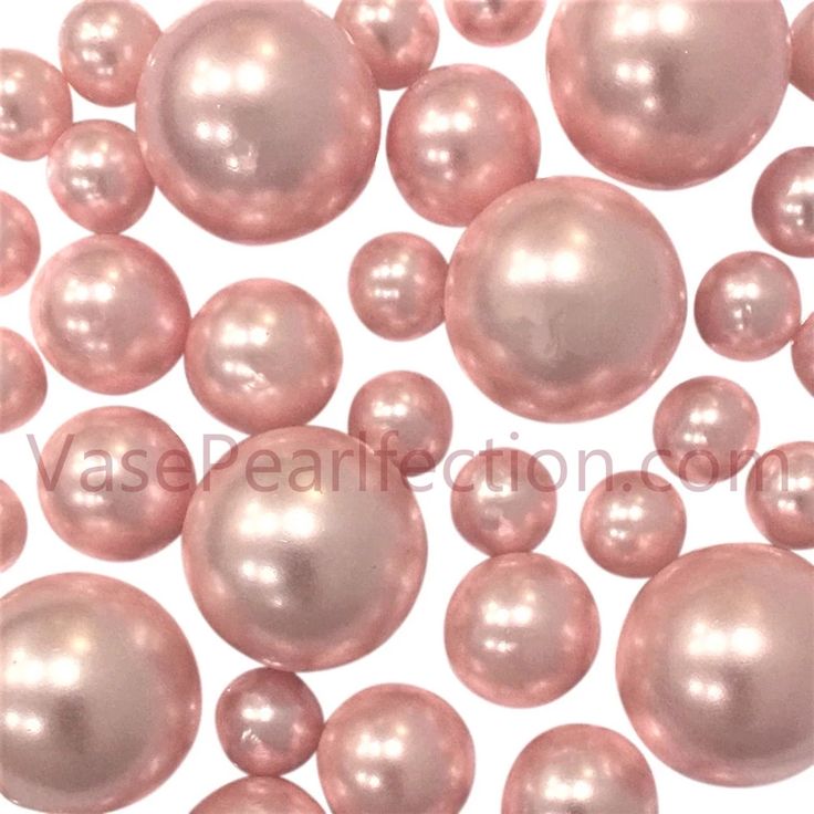 some pink pearls are scattered on top of each other