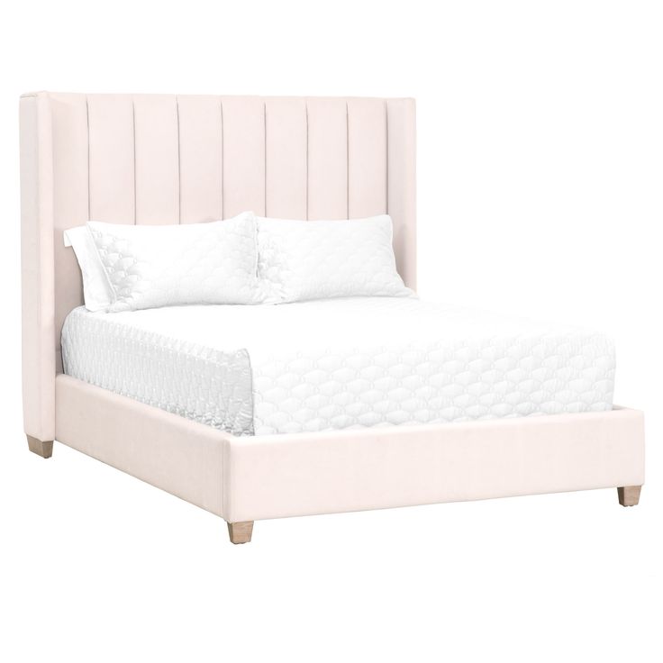 a white bed with two pillows on top of it and a night stand underneath the headboard