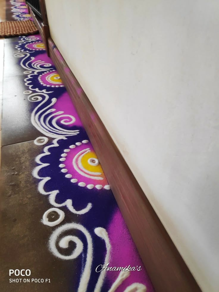 the hallway is decorated with colorful designs on the wall and floor, along with an area rug