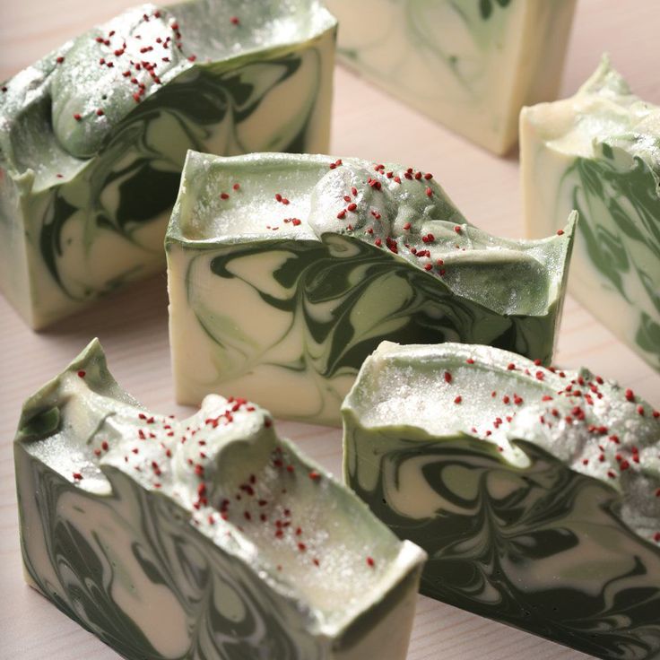 several pieces of green and white soap with sprinkles on them sitting on a table