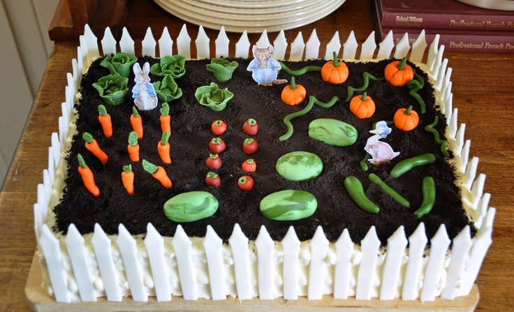 a cake with carrots, radishes and people in the garden on it