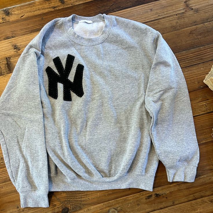 Nwot, Never Worn, Crew Neck Sweatshirt With Embroidered Felt Ny Emblem. Slightly Oversized Size Small, Hits At Hips. Greys Anatomy Crewneck, Grey Sweatshirt Embroidery, Gray Embroidered Logo Top For Streetwear, Gray Tops With Embroidered Logo For Streetwear, Letter Embroidery Crew Top For Streetwear, Streetwear Crew Neck Top With Letter Embroidery, Oversized Sweater With Embroidered Logo, Gray Relaxed Fit Tops With Embroidered Logo, Crew Neck Tops With Letter Embroidery For Streetwear