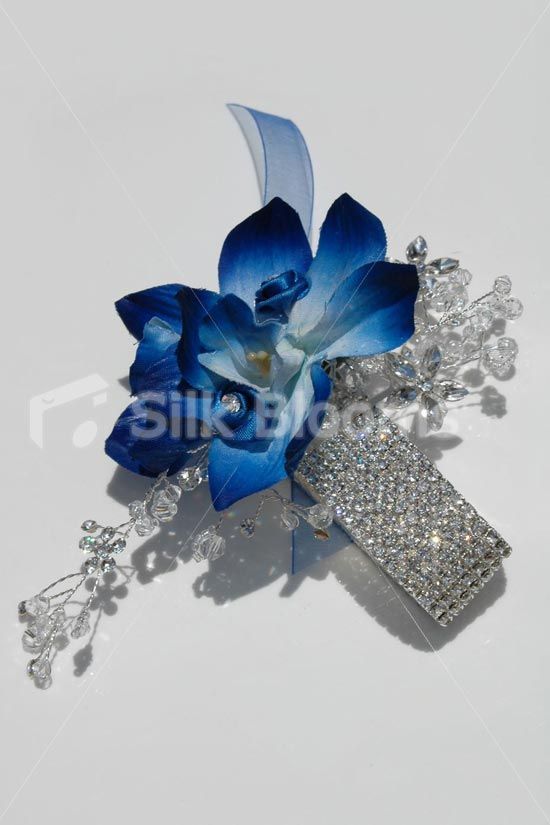 a blue flower and crystal cross broochle on a white background stock photo, image